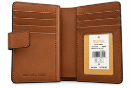 Michael Kors Jet Set Travel medium bifold zip coin wallet in Brown open interior with card slots and product tag